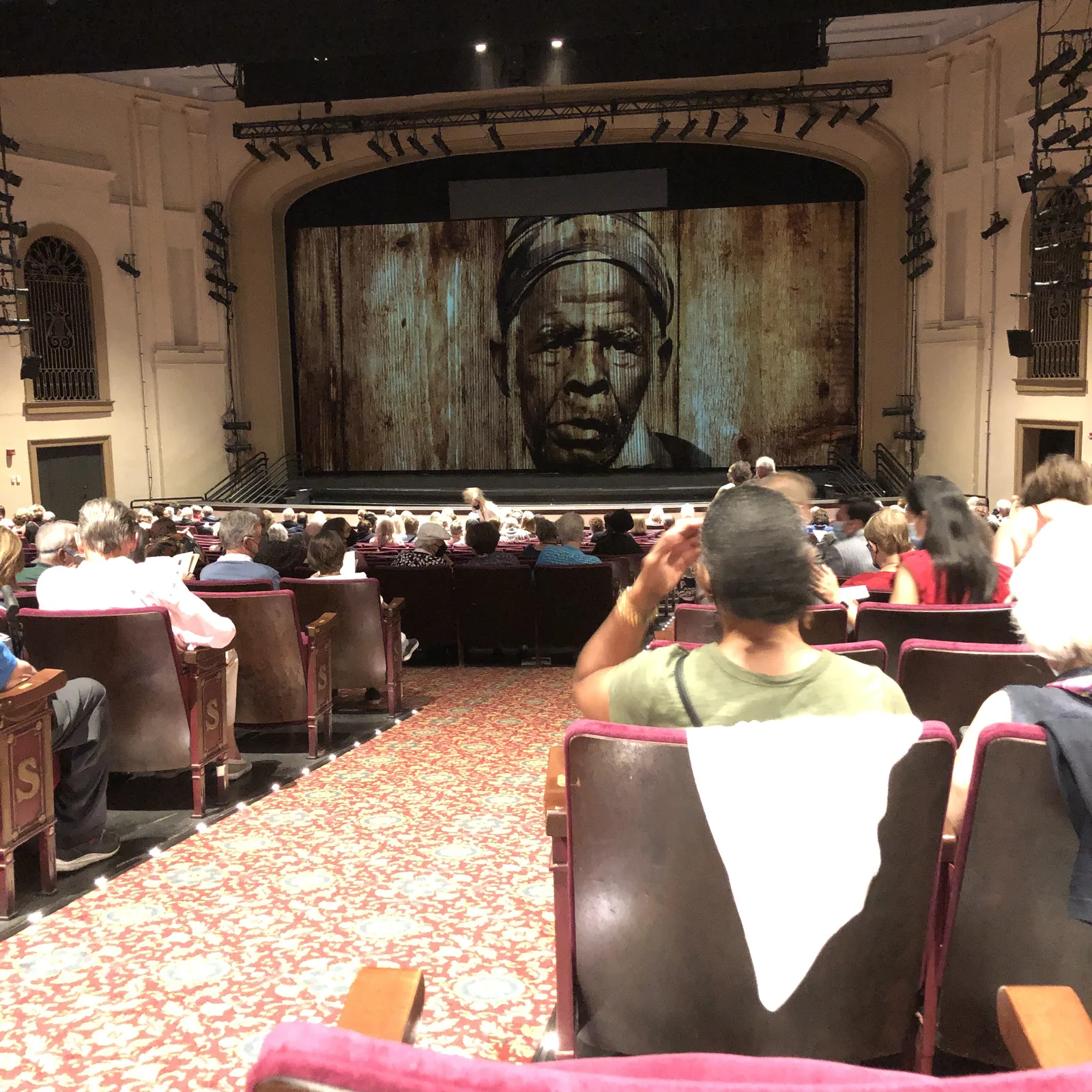An audience seated before the curtain at the Sottile Theatre